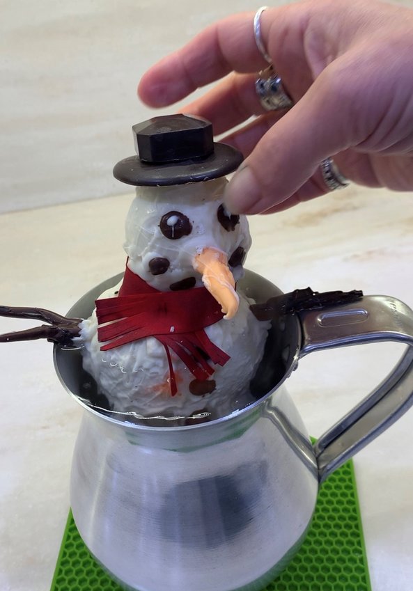 Pour boiling water into large mug. Drop snowman in. Stir and enjoy!